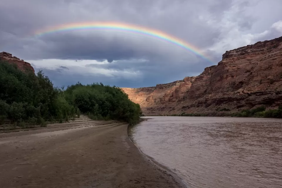 Rainbow over red rocks and river in Utah's Labyrinth Canyon.